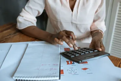 Person using a calculator to work out salary after taxes
