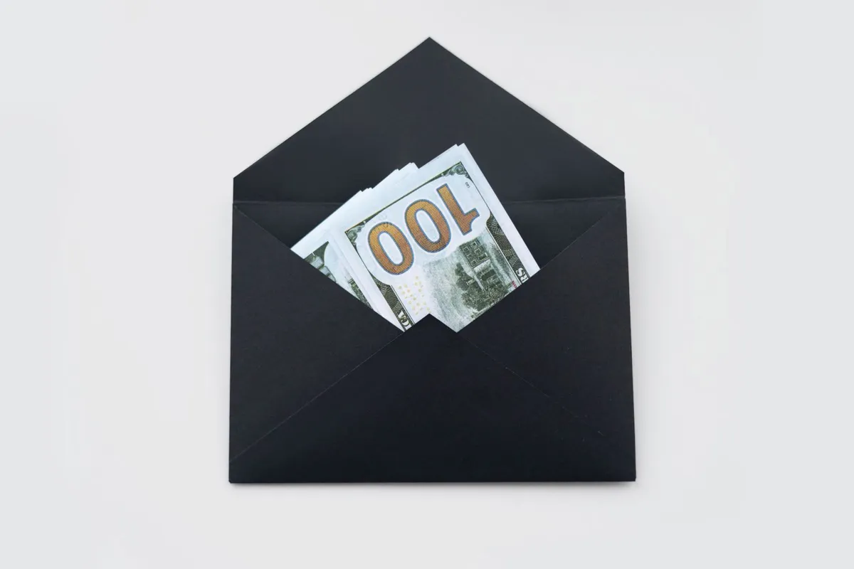 Envelope holding hundred-dollar bills, like a cash bonus