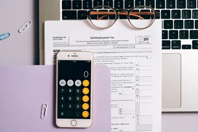 Smartphone calculator over a tax document